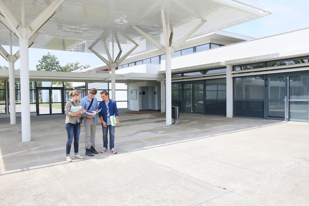 Group of students standing by school building