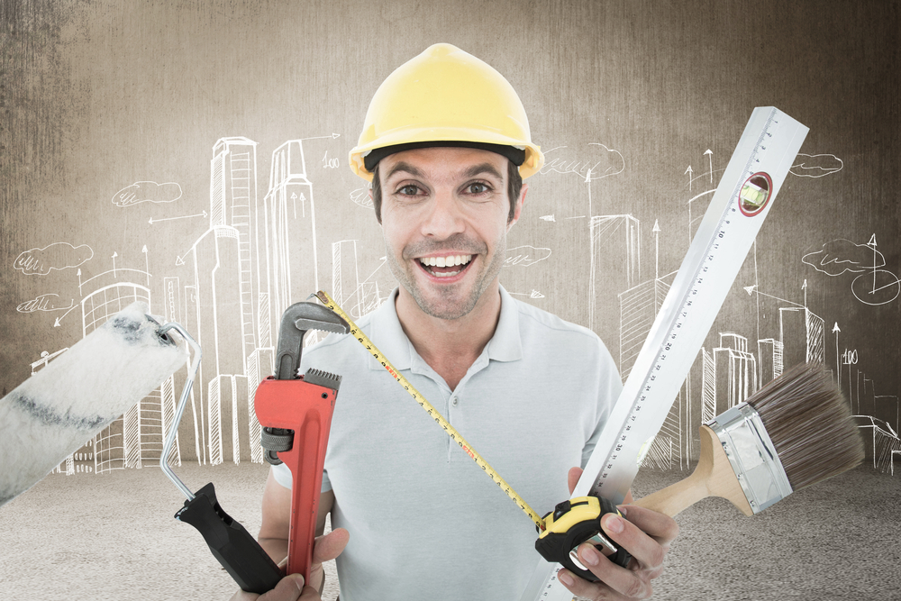 Portrait of happy worker holding various equipment against hand drawn city plan